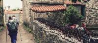 Pilgrims hiking through small village on the Camino | @timcharody