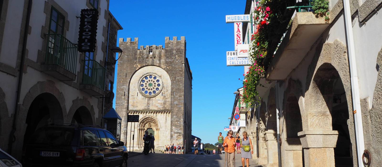 Pilgrims enjoy a stroll through Portomarin after a day walking on the Camino | Sue Finn