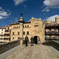 Hikers on the medieval bridge leading to Valderrobres | Kate Baker