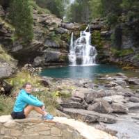 Walking resting at a waterfall in the Ordesa Canyon