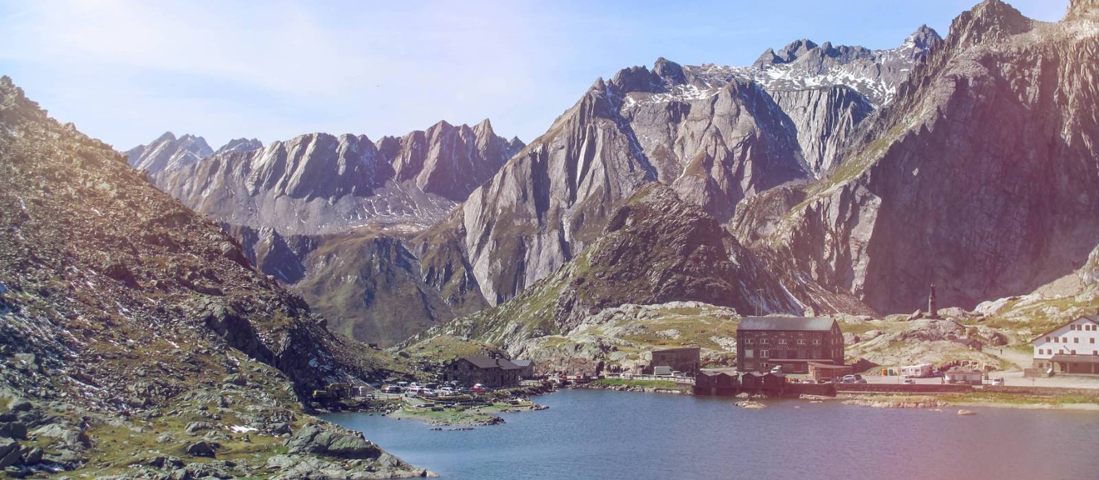 The historic Great St Bernard Pass refuge nestled between a lake and soaring mountains on the Via Francigena in Switzerland | Stephane Engler