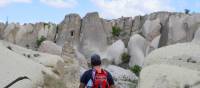 A walker in Cappadocia, walking through the rock formations | Erin Williams