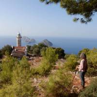 Hiker enjoying the view of Cape Gelidonia lighthouse and the 'Five Islands' | Lilly Donkers