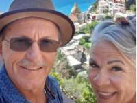 Traveller Cindy and her husband taking a selfie with the Amalfi Coast |  <i>Cindy S.</i>