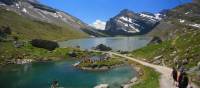 Hikers skirting glacial lakes on the way to Gemmi pass