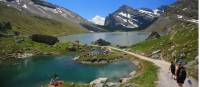 Hikers skirting glacial lakes on the way to Gemmi pass