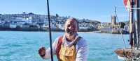 A happy Cornish fisherman in St Ives | Visit Britain