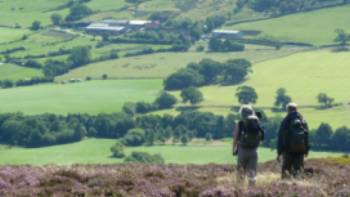 A couple enjoying the beautiful scenery on Wainwright's Coast to Coast | John Millen