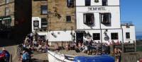 Walkers celebrating the end of the Coast to Coast in Robin Hood's Bay | John Millen