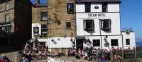 Walkers celebrating the end of the Coast to Coast in Robin Hood's Bay | John Millen