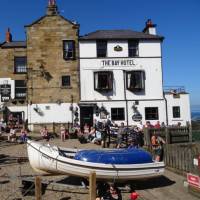 Walkers celebrating the end of the Coast to Coast in Robin Hood's Bay | John Millen