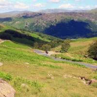 Cyclist on the road up from Borrowdale to the Honister pass | John Millen