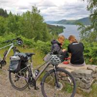 Cyclists overlooking Great Glen & Loch Ness in Scotland | Janette Crighton