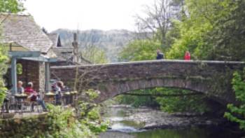 Walkers taking a rest at Grasmere Bridge on the Coast to Coast trail | John Millen