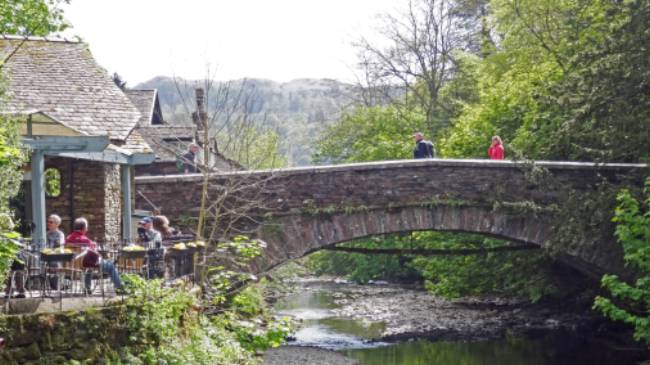 Walkers taking a rest at Grasmere Bridge on the Coast to Coast trail | John Millen