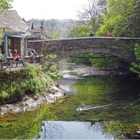 Walkers taking a rest at Grasmere Bridge on the Coast to Coast trail | John Millen