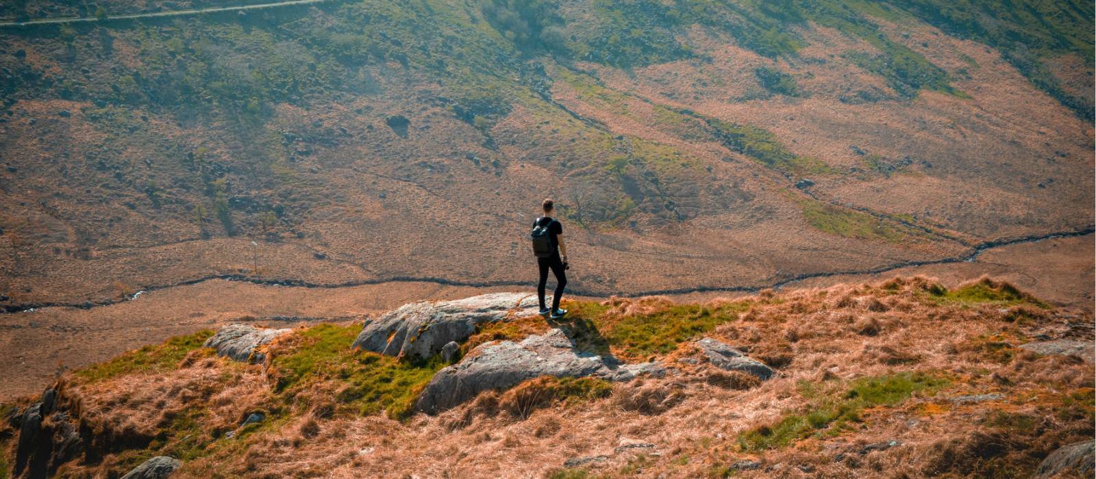 Hiker on a lush hillside in Snowdonia National Park
 | Zoltan Fekeshazy