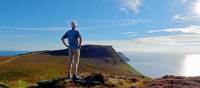 A walker enjoys a hilltop view on the Isle of Man