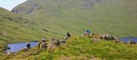 Walkers enjoy a break at Grisedale Tarn mountain lake | John Millen