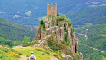 A walker follows the path to Chateau de Rochebonne | Keith Starr