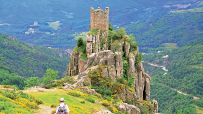 A walker follows the path to Chateau de Rochebonne | Keith Starr