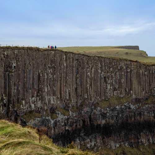 Hikers on the basalt cliffs of the Giant's Causeway