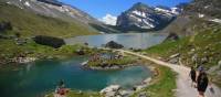 Hikers skirting glacial lakes on the way to Gemmi pass