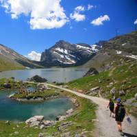 Hikers skirting glacial lakes on the way to Gemmi pass