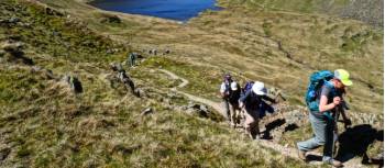 Hikers above Grizedale Tarn in the Lake District | John Millen