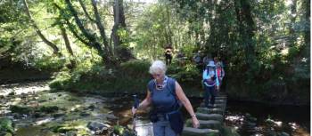 Senior walkers cross a river in England | John Millen